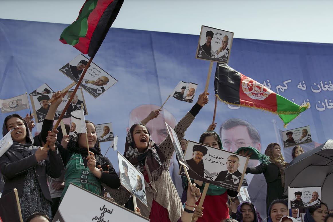 Young women cheer as they attend a rally for the Afghan presidential candidate Ashraf Ghani. (Kabul, April 1, 2014)