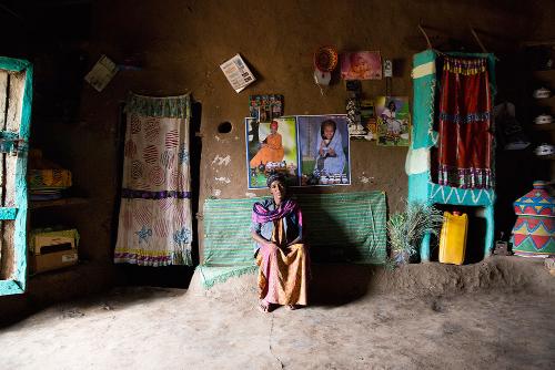 Christina Czybik - Tailor and farmer Silma sitting in her colorful living room in Mendeya