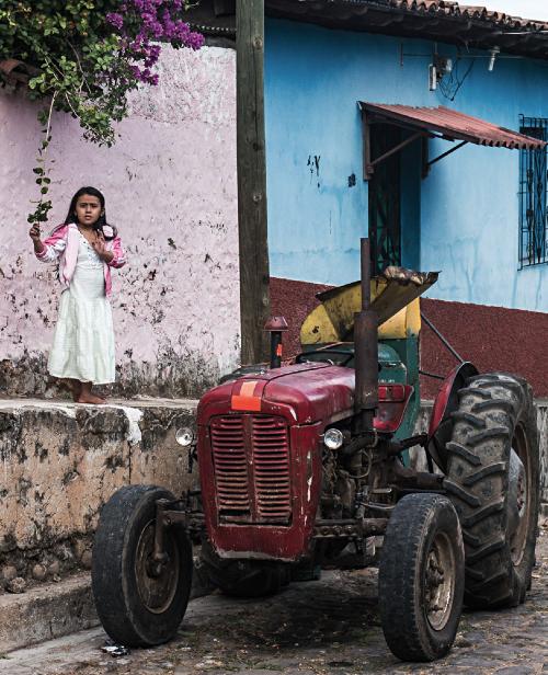 John Sevigny - A young girl in the village of Suchitoto, El Salvador stands in front of her home.